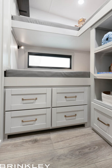| Model Z 2810 Fifth Wheels 37 Deep storage drawers located under the bottom bunk in a Brinkley Model Z 2810 Fifth Wheel, showcasing spacious capacity and high-quality dovetail wood construction.