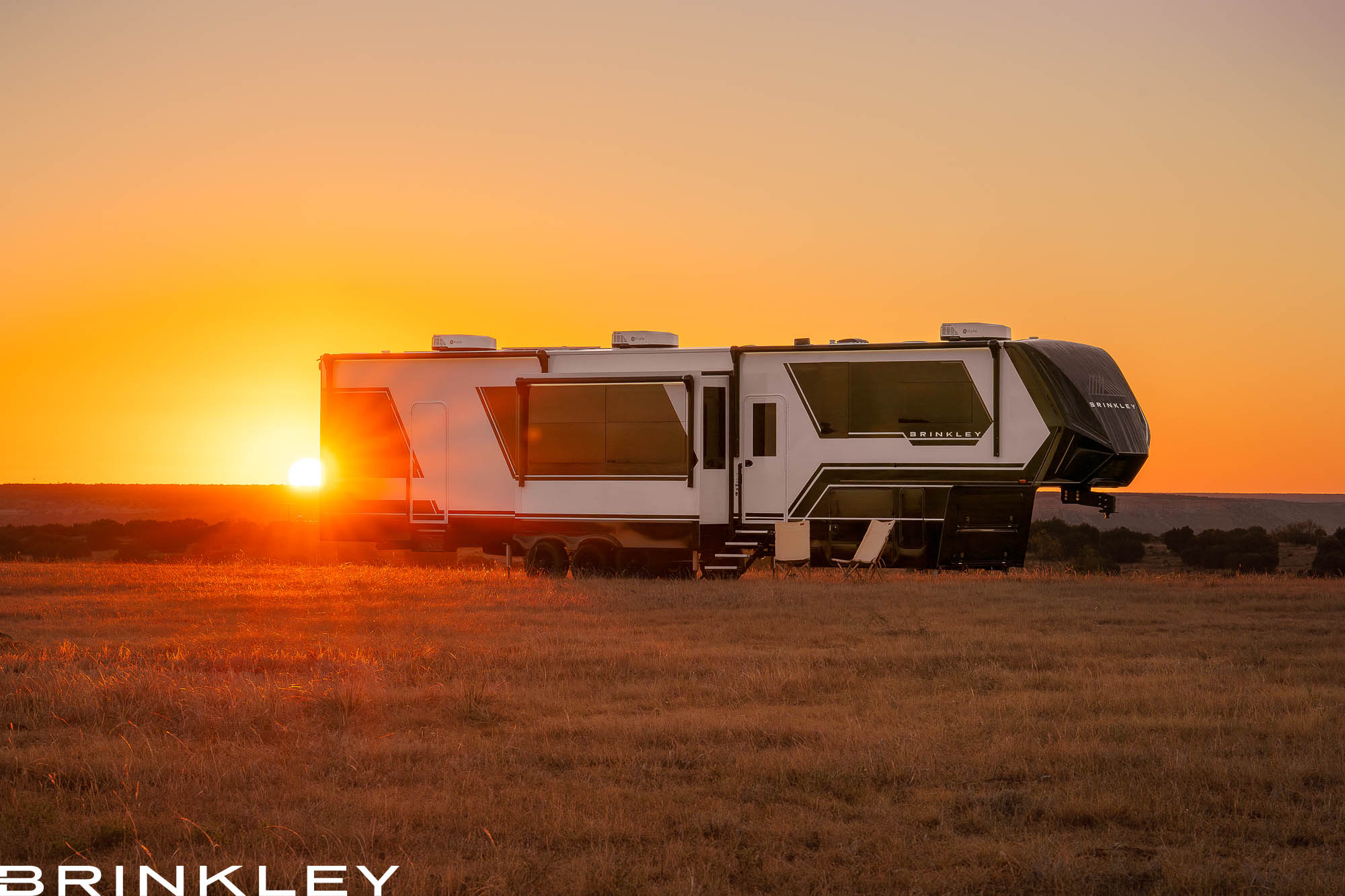 | Model G Fifth Wheel Toy Hauler Line 116 Brinkley Model G Luxury Fifth Wheel Toy Hauler in Premium Exterior RVing at Sunset or Sunrise in Texas Doves Rest Resort and Cabins