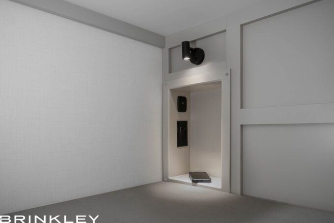 | Model Z 2810 Fifth Wheels 36 Close-up of the lower bunk storage cubby in a Brinkley Model Z 2810 Fifth Wheel, featuring built-in power outlets, USB charging ports, and white shelving for device storage.
