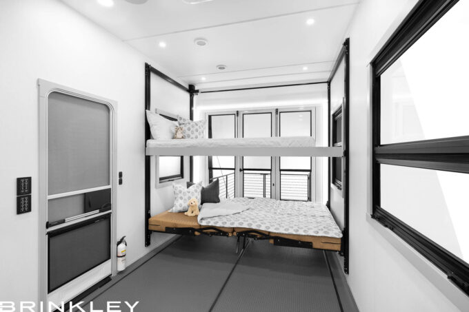 | Model G 4100 Toy Haulers 10 RV garage interior showing Happijac overhead bunk lowered and lower sofas converted into a bed.